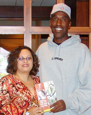 Mi-Ling is shown with college friend Trent Tucker, former NBA player.